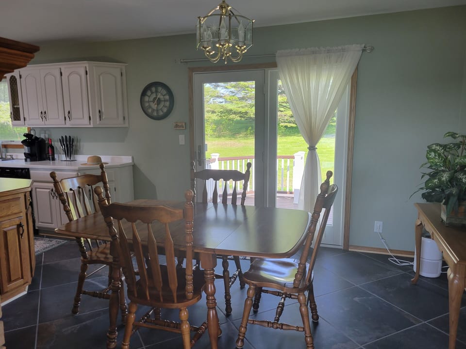 Dining area leading out to back deck and parking