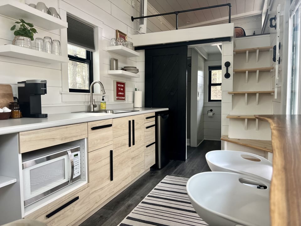 The kitchen has plenty of countertop space and all the amenities you need to make a great meal, including a microwave, mini-refrigerator, toaster oven, portable cooktop (with pots and pans), and a Keurig coffee maker (with basic coffee pods).
