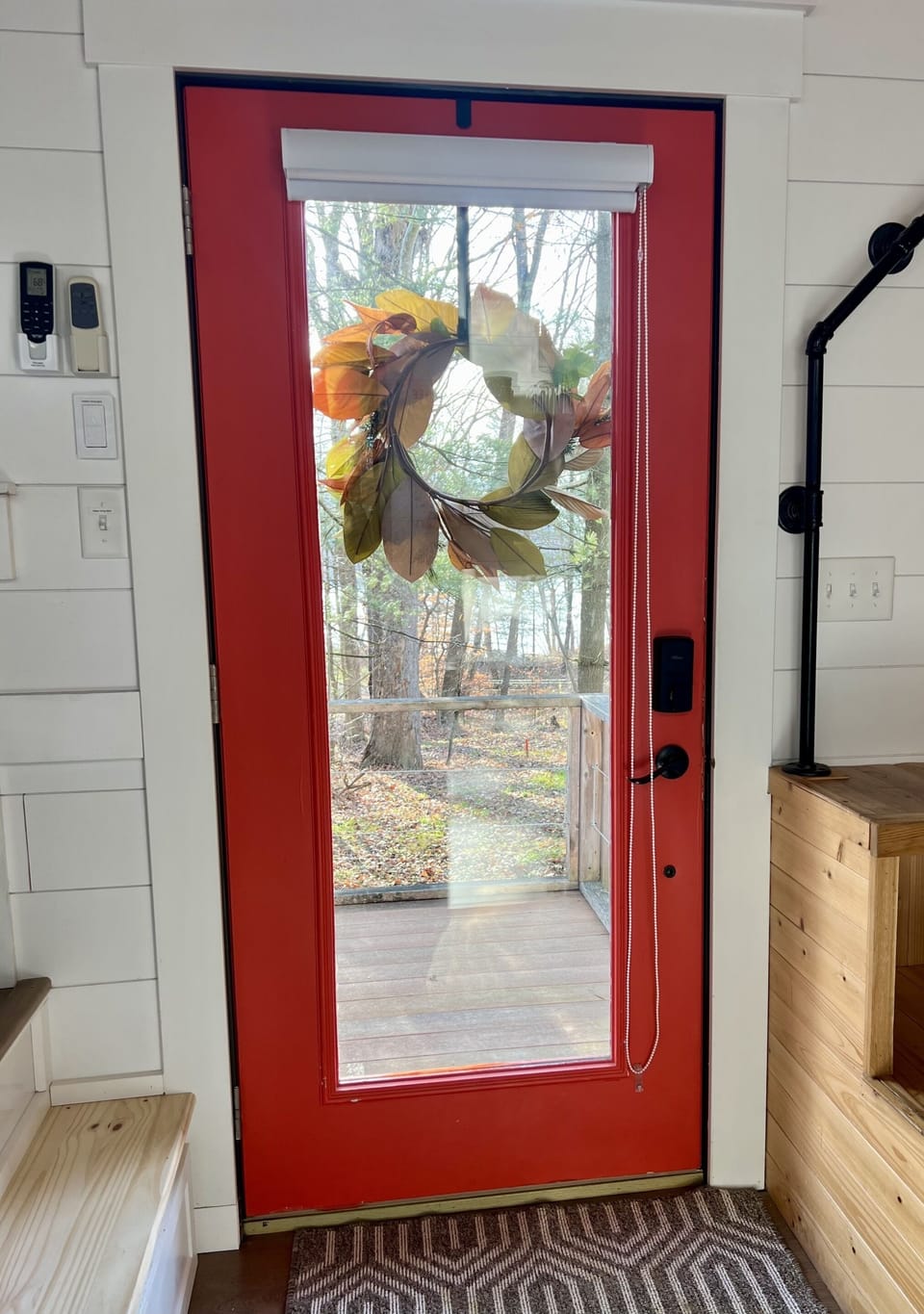The "gladiola red" front door lets in plenty of sunshine and provides a great view of the lake.