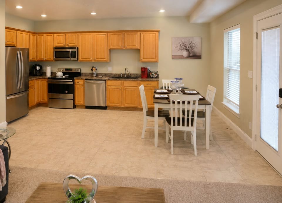 Bright open kitchen with stainless appliances and cozy dining for four