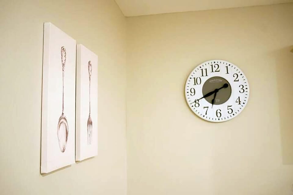 Minimalist dining nook decor with modern clock and elegant wall art