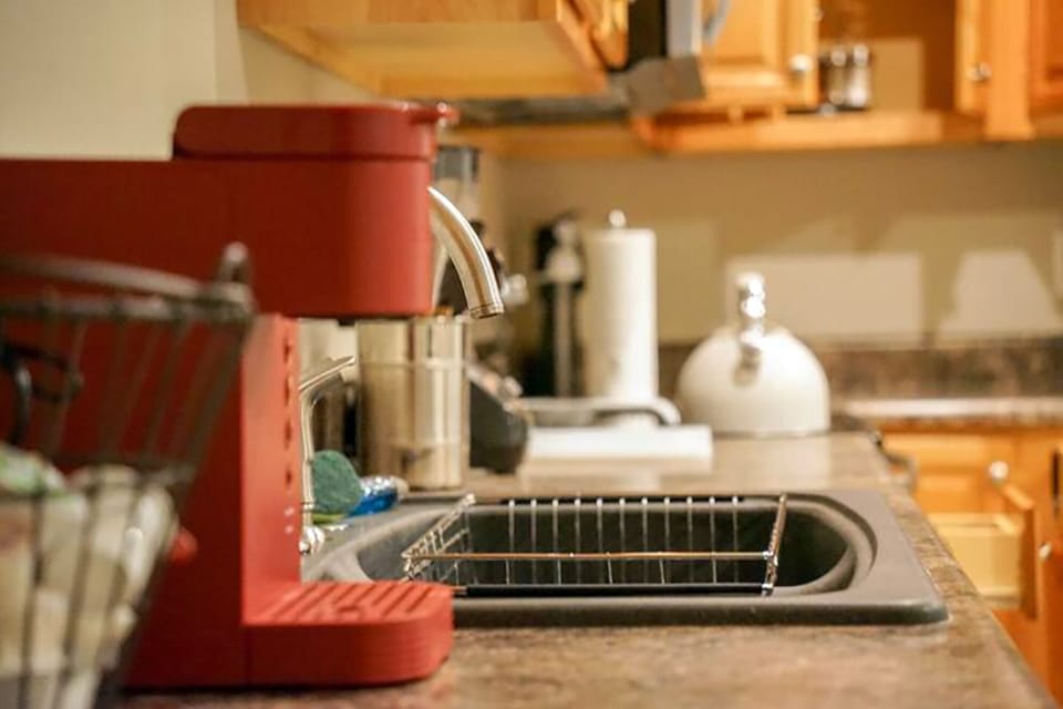 Cozy kitchen with coffee maker, sink, and warm wood cabinetry