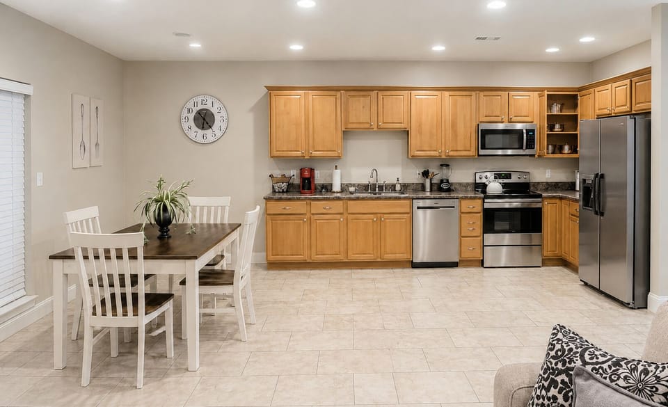 Bright open kitchen with dining for 4 and stainless steel appliances