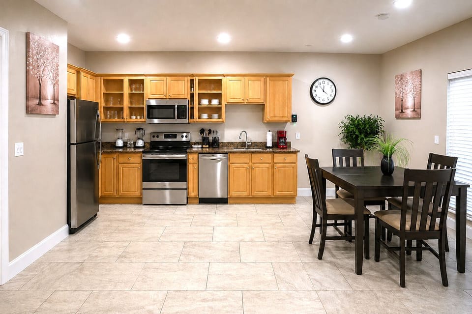 Bright open kitchen with dining space and stainless steel appliances