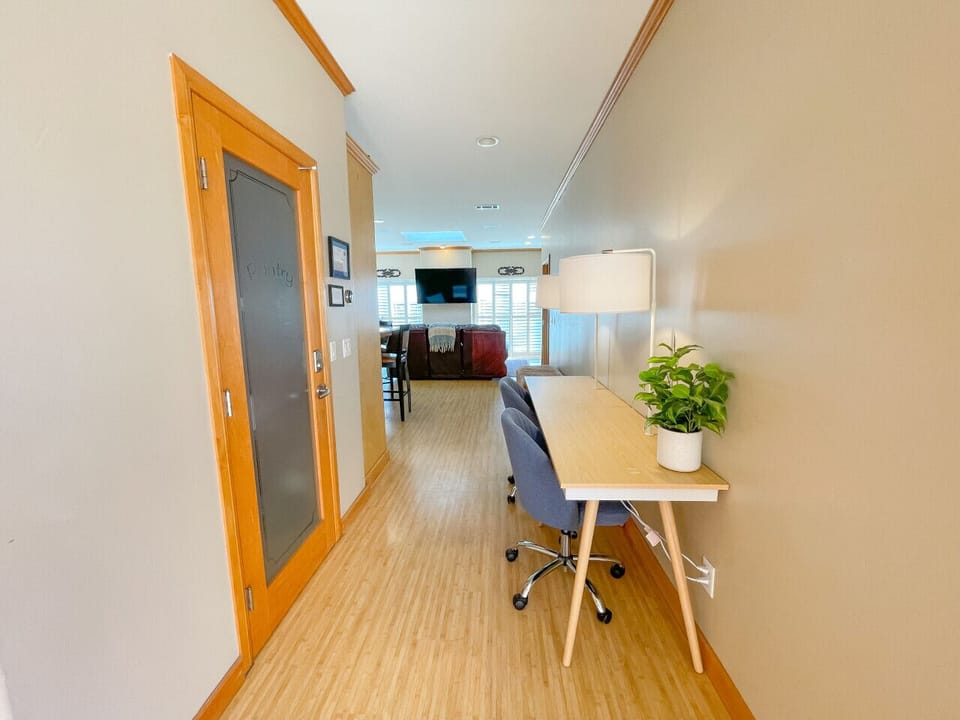 Office area with 2 desks off of living room & kitchen
