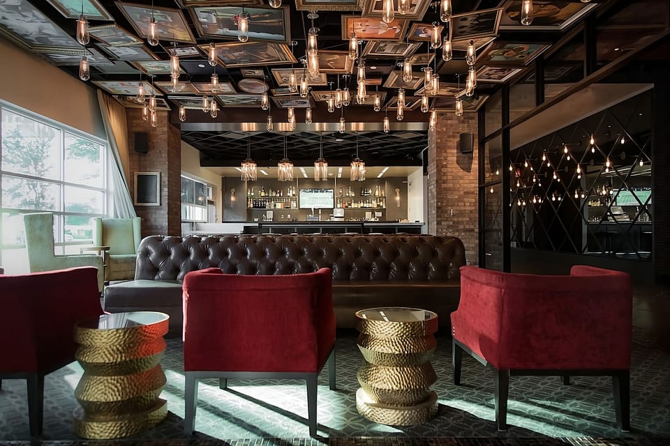Unwind beneath dramatic lighting in a stylish, intimate lounge.