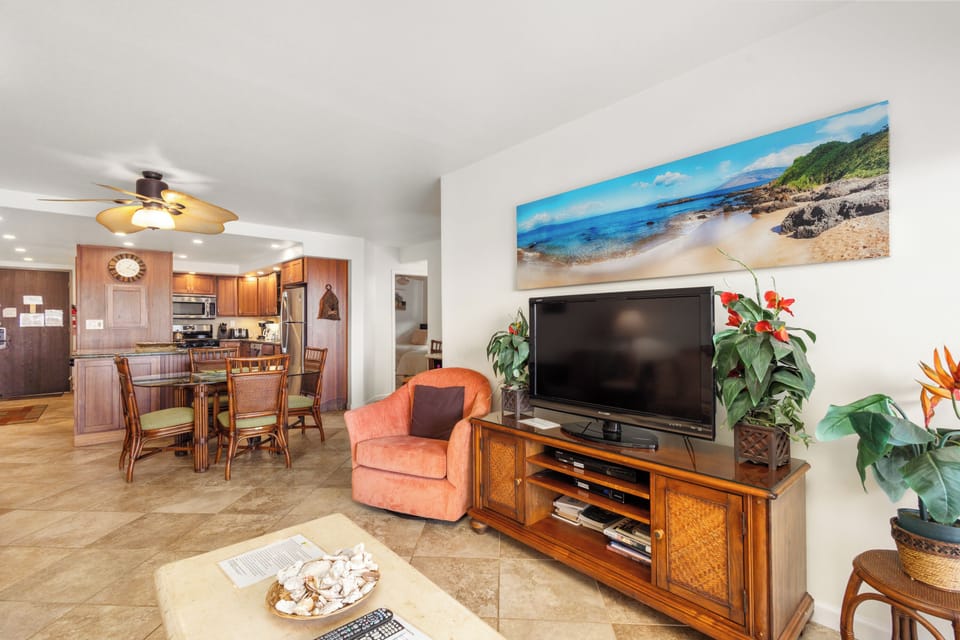 Relax in your bright, island-inspired living space with tropical touches, comfortable seating, and a full entertainment setup. The open layout flows into a full kitchen and dining area, perfect for gathering and unwinding.