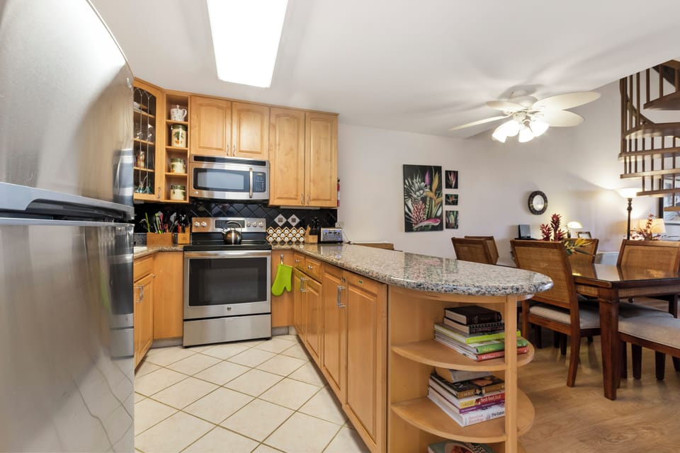 Step into your fully equipped kitchen with granite counters, stainless appliances, and a breakfast bar that flows into the cozy dining area—perfect for home-cooked meals and memorable evenings together.