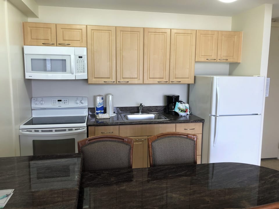 Your fully equipped kitchen has everything you need to cook up a delicious meal, with a spacious dining table ready for gathering and enjoying great food together.
