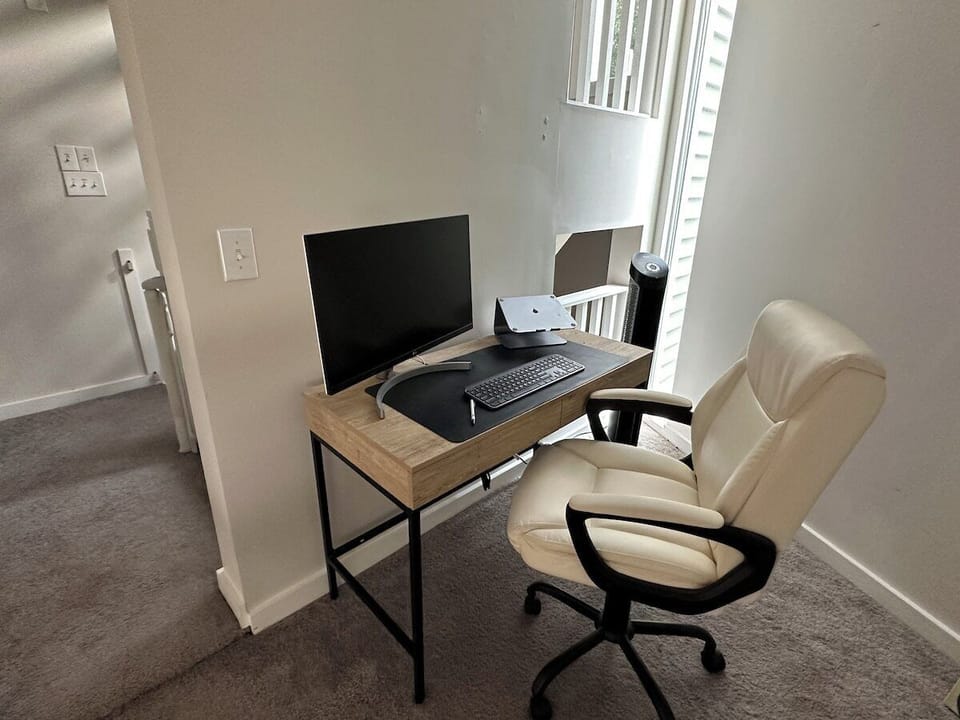 Additional work space with desk and monitor