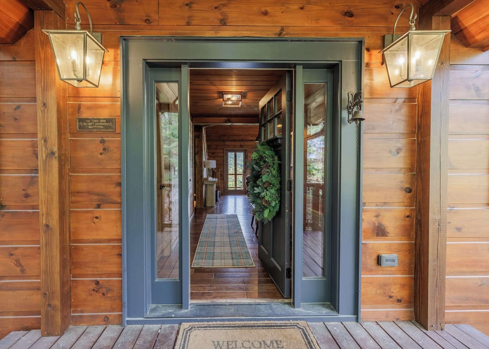 Rustic cabin front porch with mountain cabin charm — your first step into Above the Clouds, a Blue Ridge vacation rental in North Georgia.