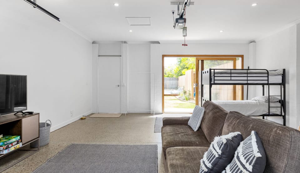 Detached children's retreat with single bunks and living area 