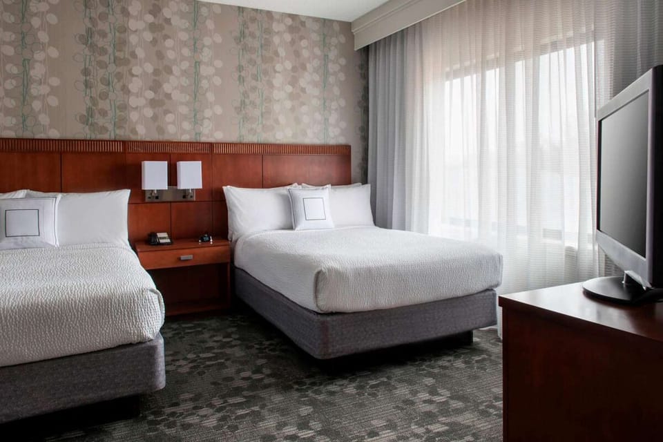 Unwind in crisp bedding with easy TV viewing.