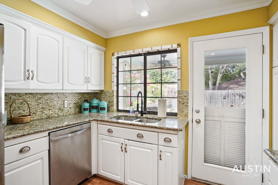 Full kitchen with all the essentials plus dishwasher and door to the patio