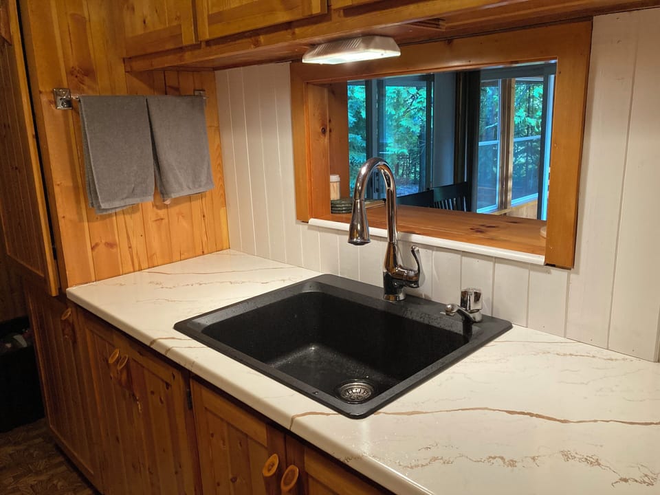 Large kitchen sink with a serving window to the dining room.