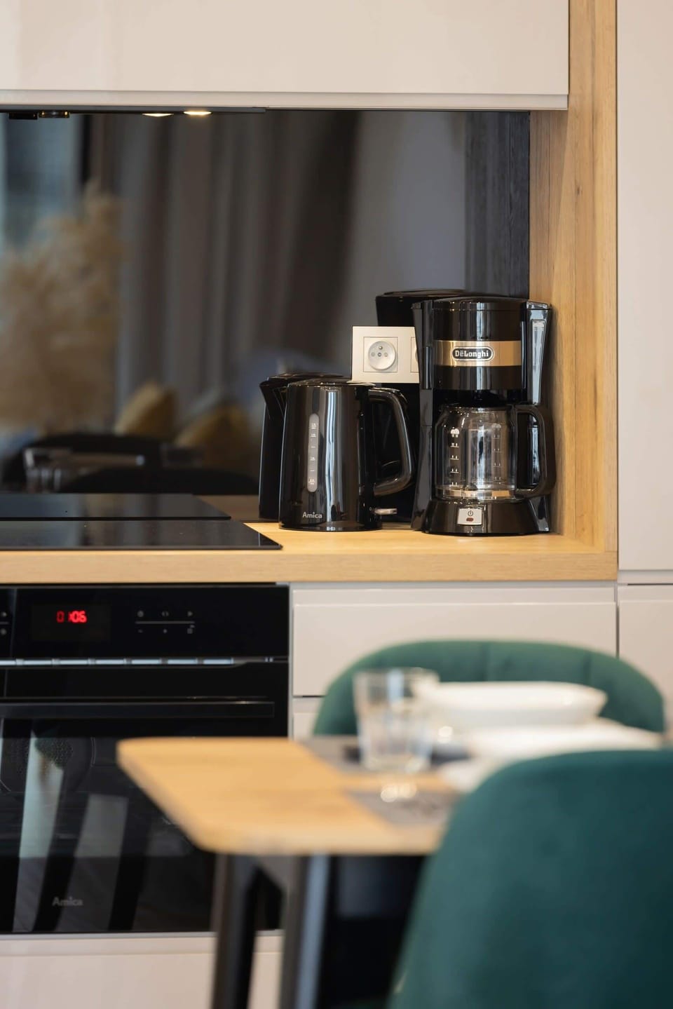 Close-up of a coffee and tea station, complete with a coffee machine and kettle for guest convenience.


