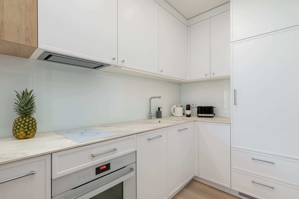 Close-up of a kitchen corner showing modern appliances, including a kettle and a toaster, for added convenience.

