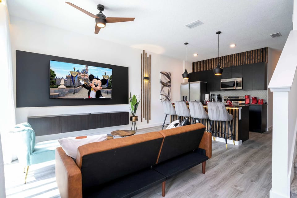Open-concept living with playful Disney touches and modern styling-stream on the big-screen TV while the sleek kitchen and island seating for four make meals easy!