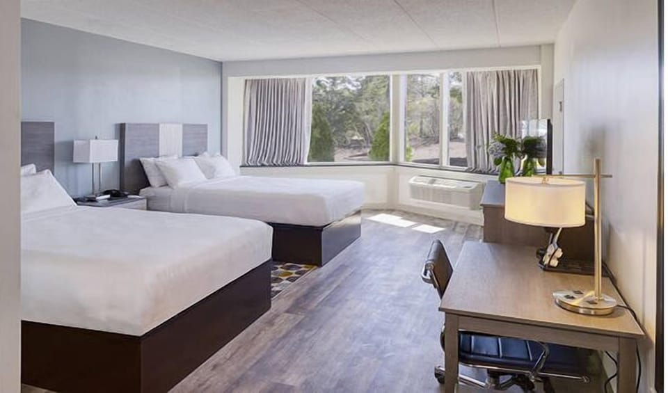 Spread out comfortably with two queen beds and work desk.