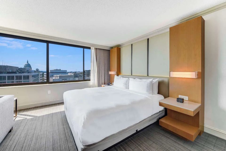Wake up to sunlight and sweeping city views beyond.