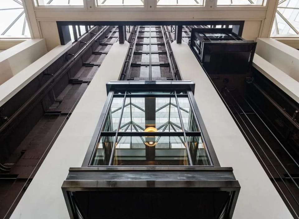 Ride up through a soaring atrium filled with daylight.
