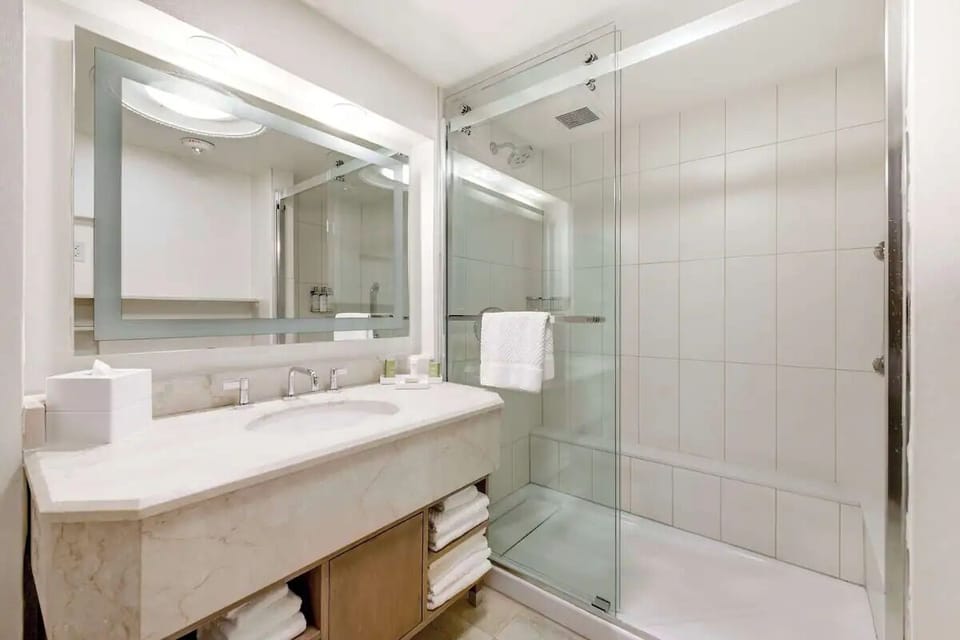 Refresh under a glass-enclosed shower with spa-clean finishes.