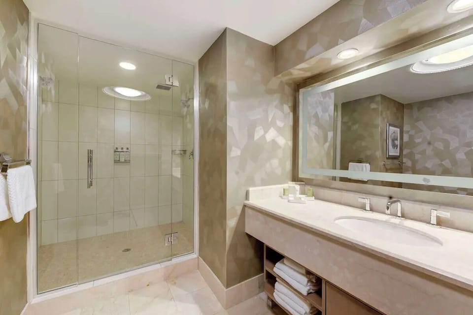 Start your day at a spacious vanity with glowing mirrors.