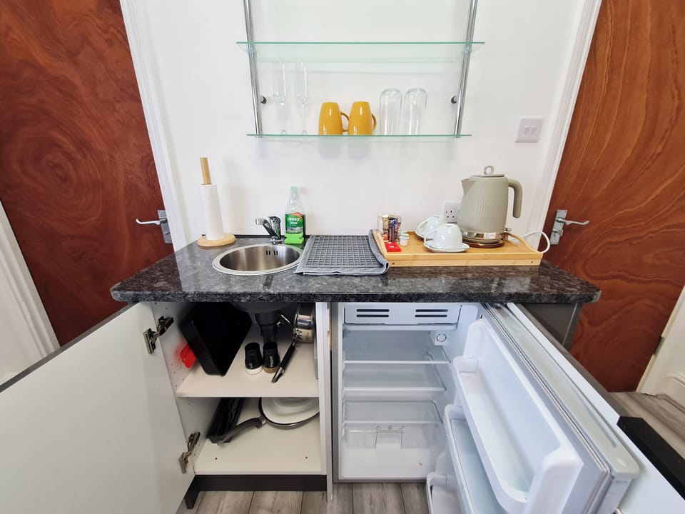 Minibar/kitchenette with fridge and cooking utensils