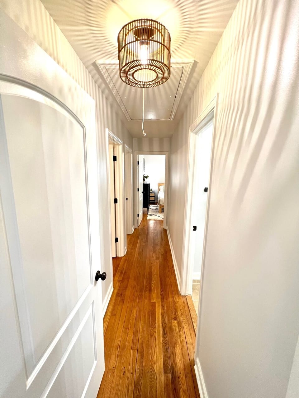 Hallway from kitchen towards bedrooms has a door to help make nap time quieter. 