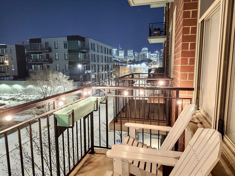 Balcony with lights + Adirondack chairs great for morning coffee and evenings.