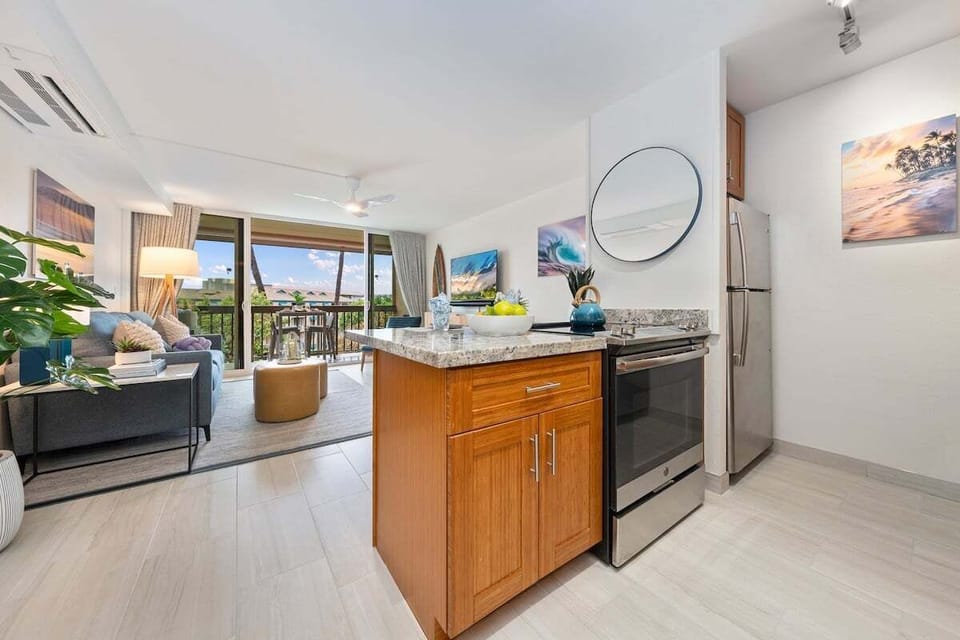Cook and connect in this inviting space that blends the kitchen, living room, and outdoor view