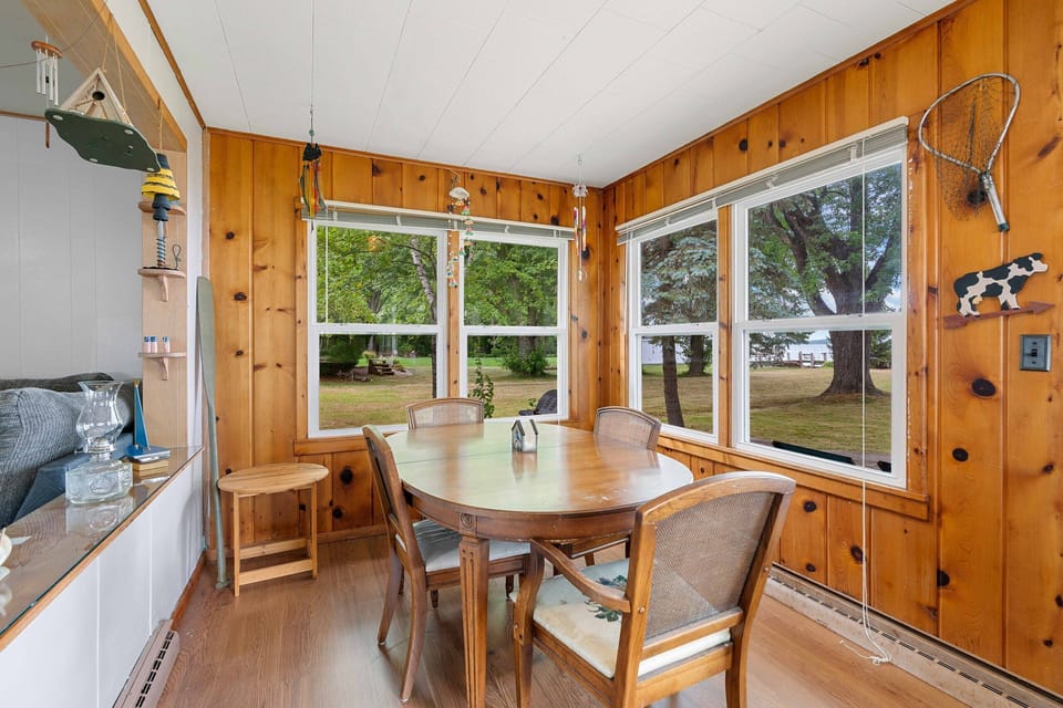 Back room features a dining table and futon for additional sleeping with gorgeous views of the lake.