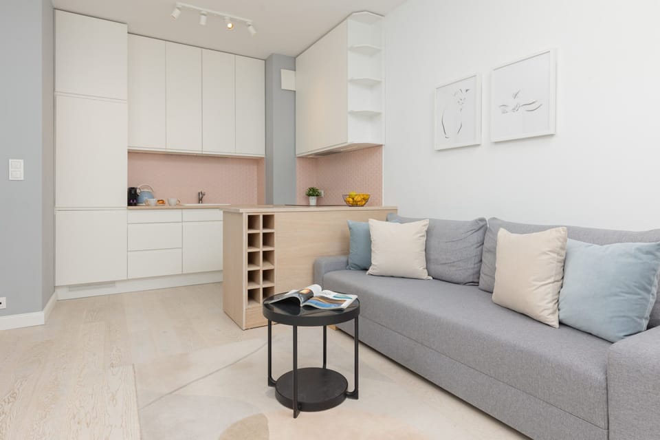 Contemporary kitchen with pink accents and sleek, minimalist storage.

