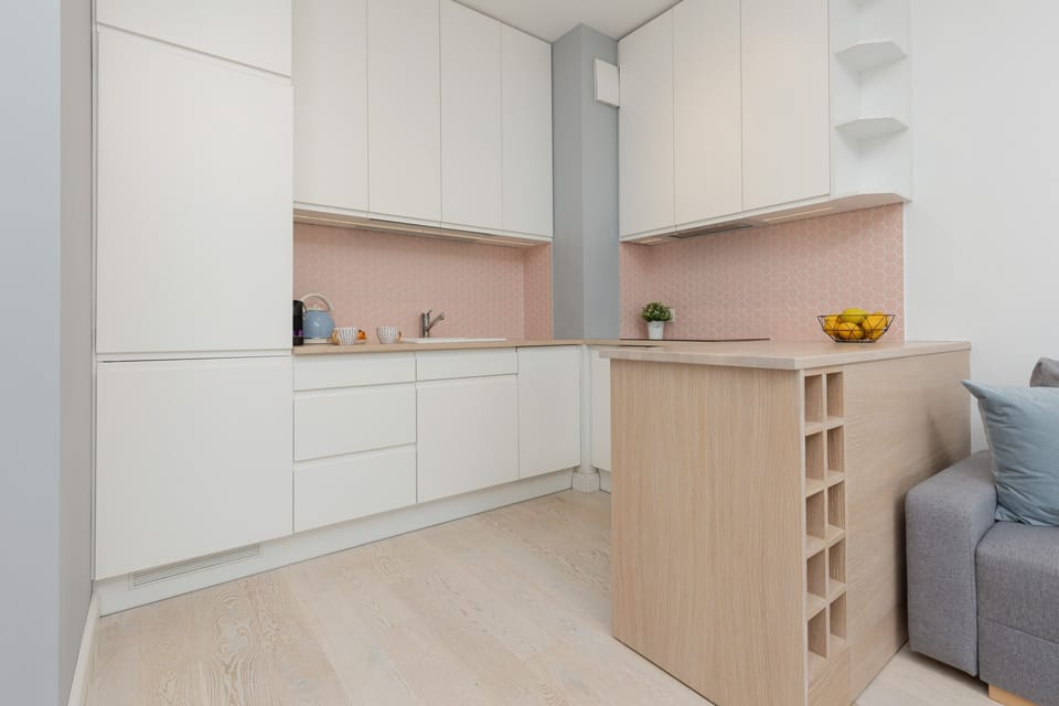 Compact kitchen area with integrated shelving and a warm, cohesive design.

