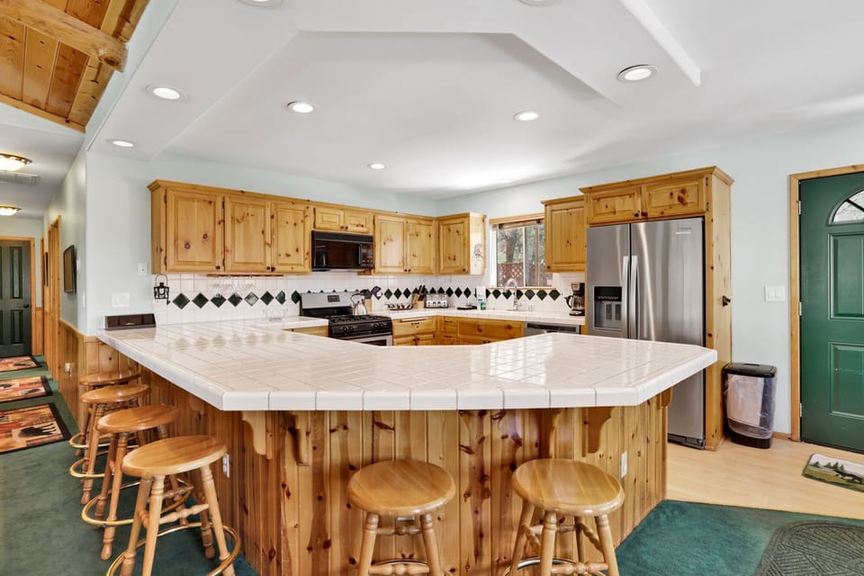 Fully equipped cabin kitchen with ample cabinetry, stove, fridge, and coffee maker—perfect for cooking meals, morning coffee, and feeling right at home on your stay.