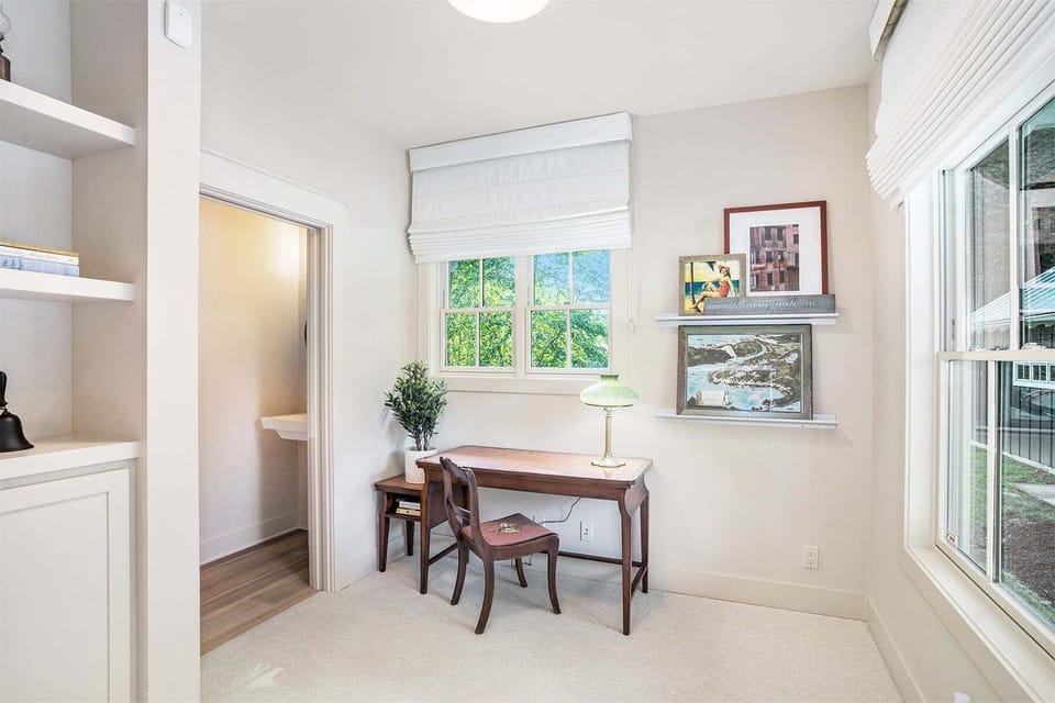 Den area near the entry has work space and a half bathroom