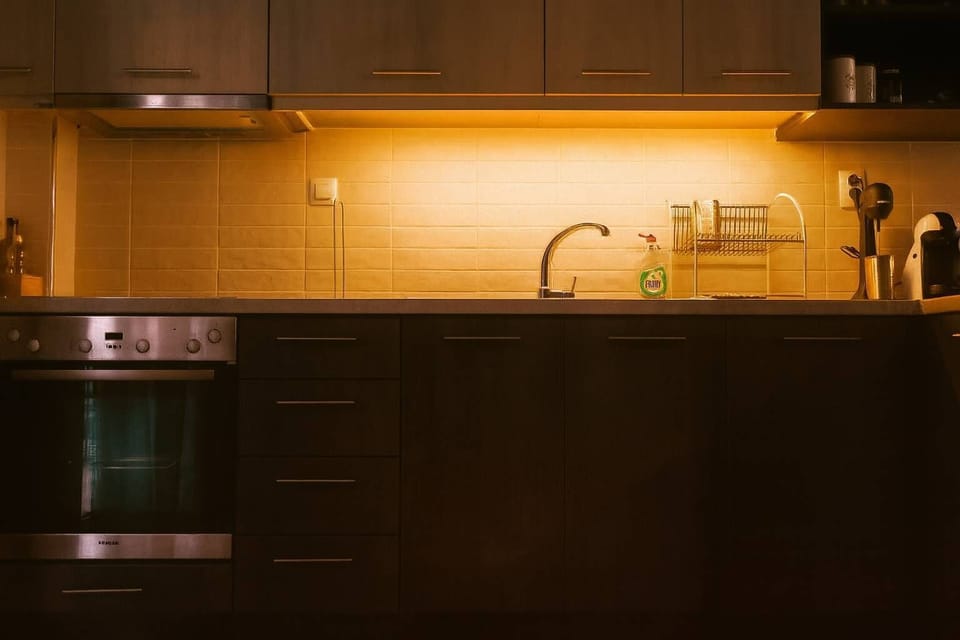 Fully Equipped Kitchen with Wood Cabinets and Undercounter Lighting

