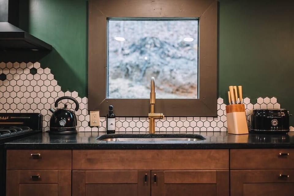 Kitchen sink with knives, toaster, kettle