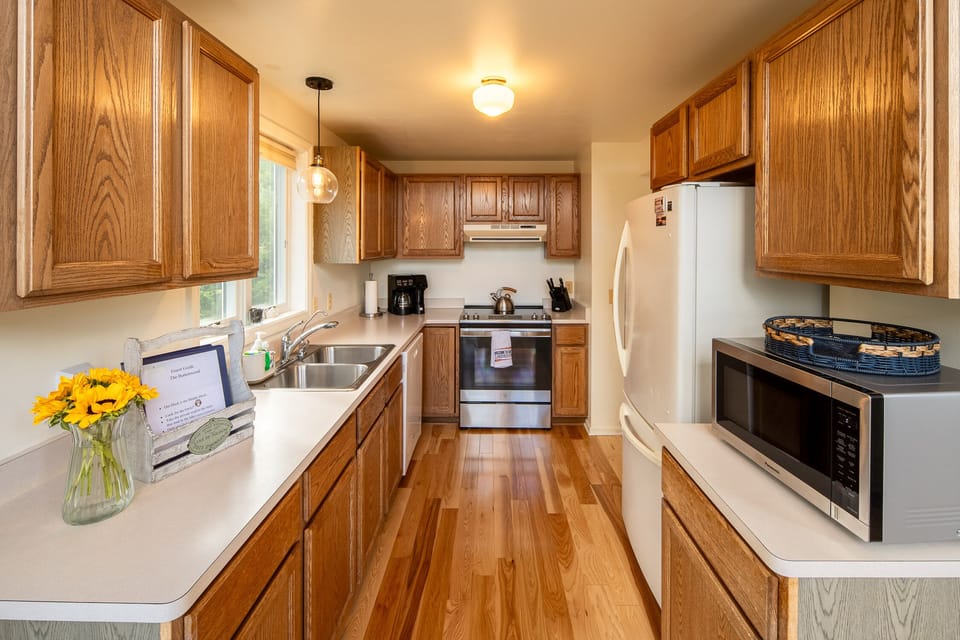 Full kitchen leads out to deck & Grill. 