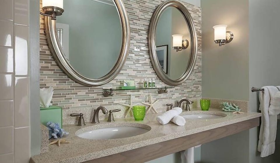Refresh at a spa-style double vanity with warm lighting.