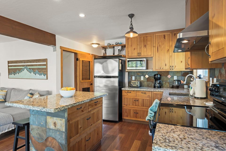 You'll love cooking in this fully-equipped kitchen with granite counters, stainless appliances, and a breakfast bar perfect for morning coffee.