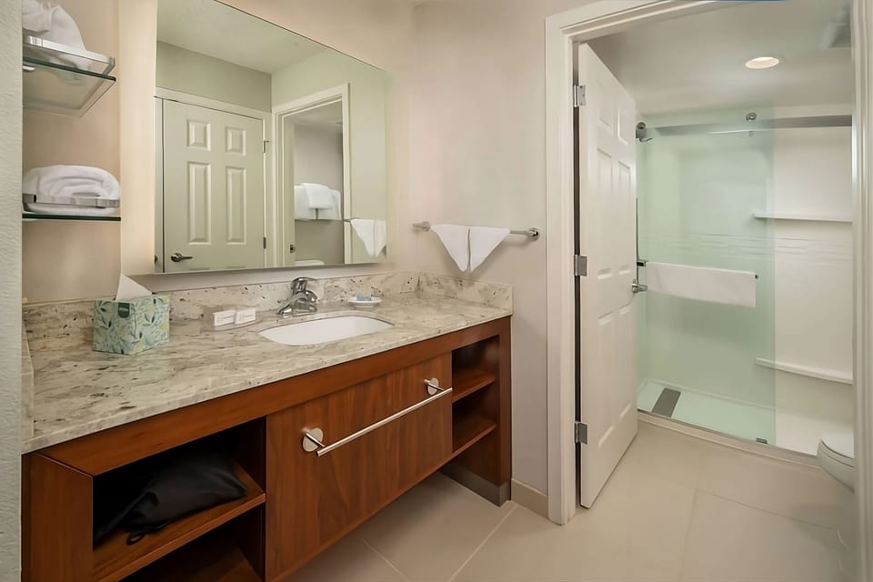 Refresh in a bright bath with glass shower and vanity.