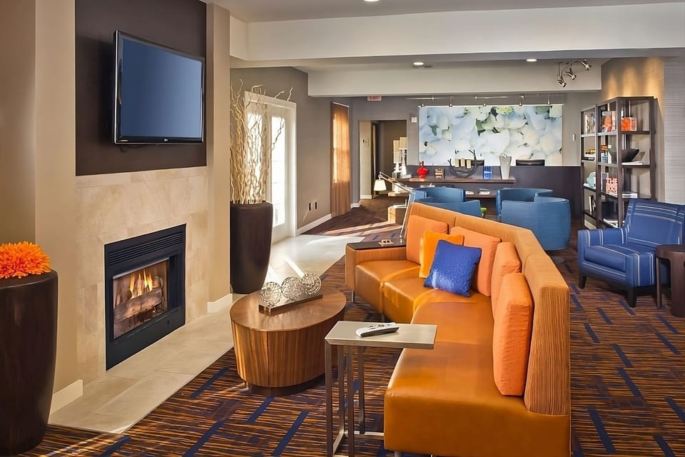 Unwind by the fireplace in a bright, modern lounge.