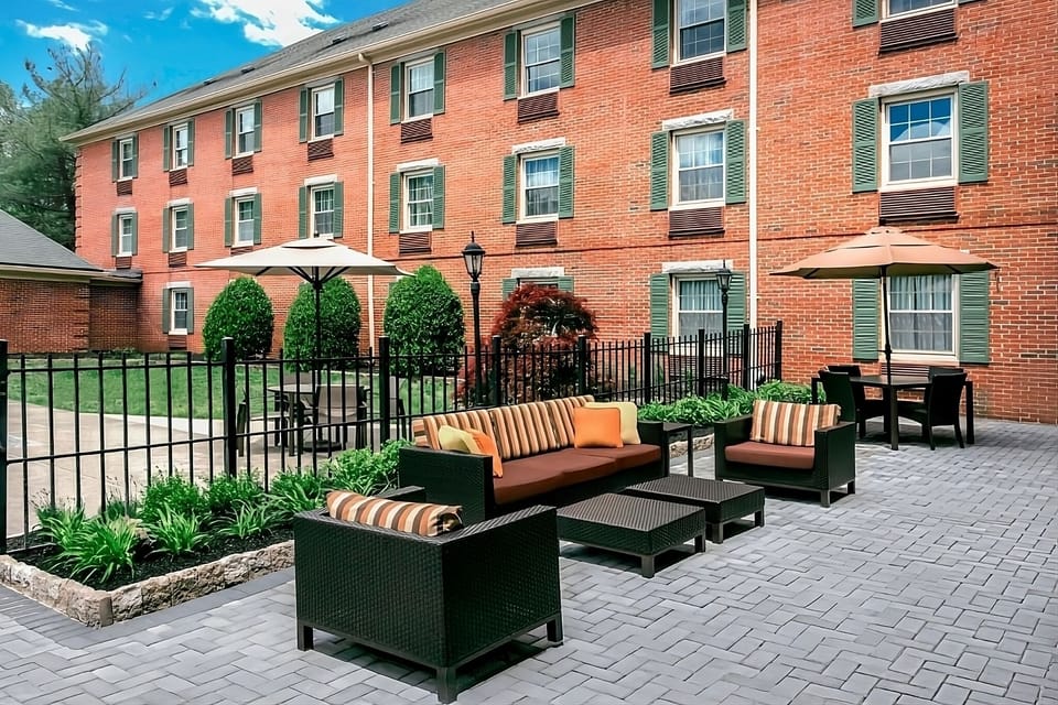 Unwind outdoors on cushioned seating for sunny afternoon chats.