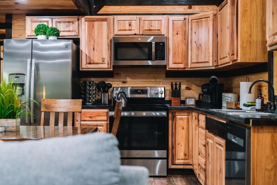 The kitchen features modern, stainless steel appliances and the kitchen essentials for a nice meal at the cabin.