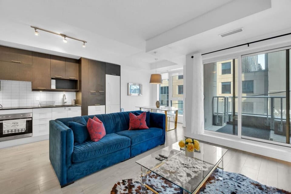 Bright, spacious, living room outfitted with designer furnishings.