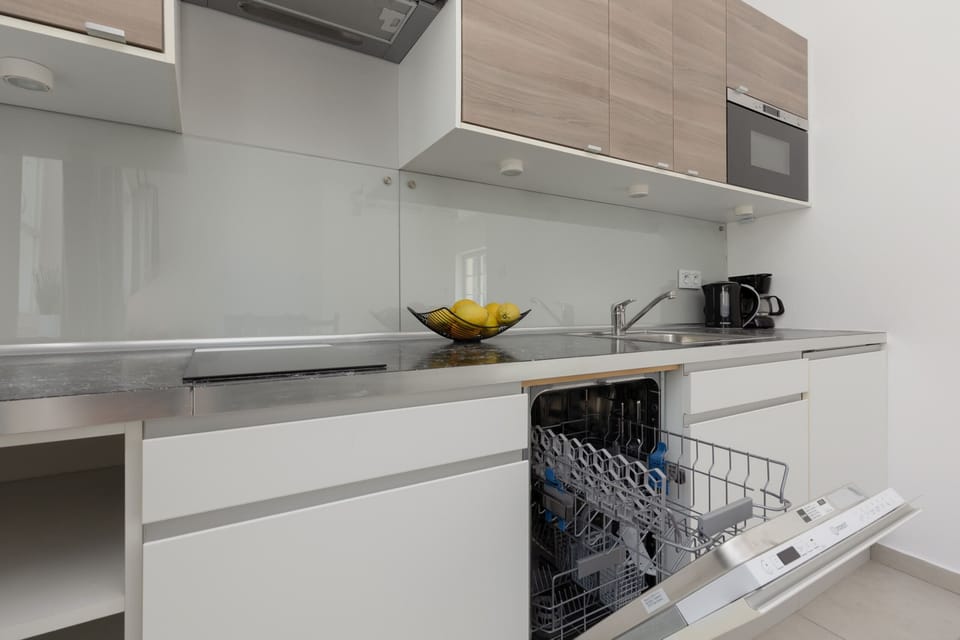 Kitchenette with plenty of kitchen utensils and dishes.