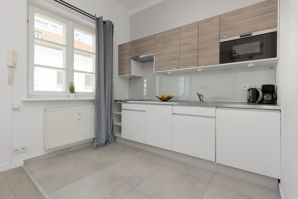 Kitchenette with plenty of kitchen utensils and dishes.