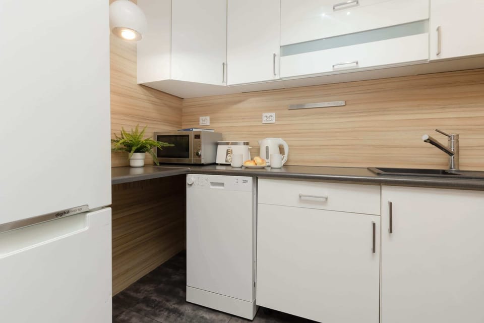 Another angle of the kitchen showcasing its practical layout and sleek design.

