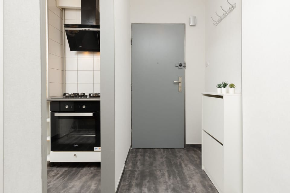 Compact kitchen area with easy access to the entryway, maximizing functionality.

